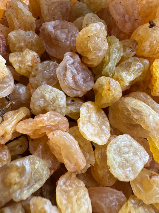 Close-up of dried raisins with a focus on texture and color.