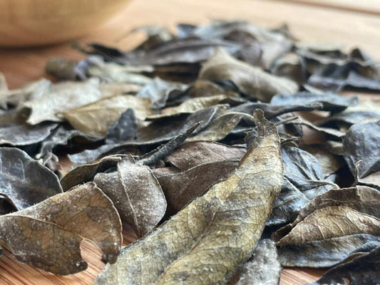 Dry curry leaves on a wooden surface