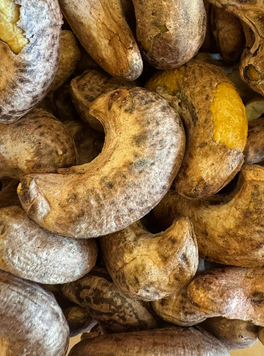 Close-up of roasted cashews with a focus on texture and color.